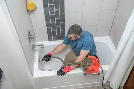 Caucasian male technician working indoors with PPE in industrial setting.